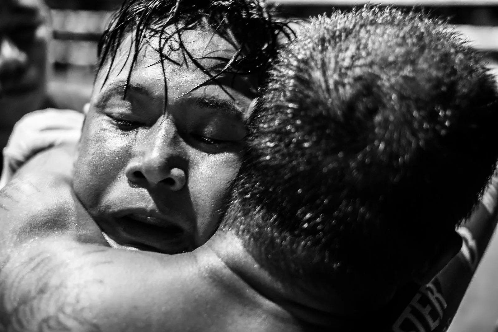 Emotional Muay Thai fighter is embraced after the bout