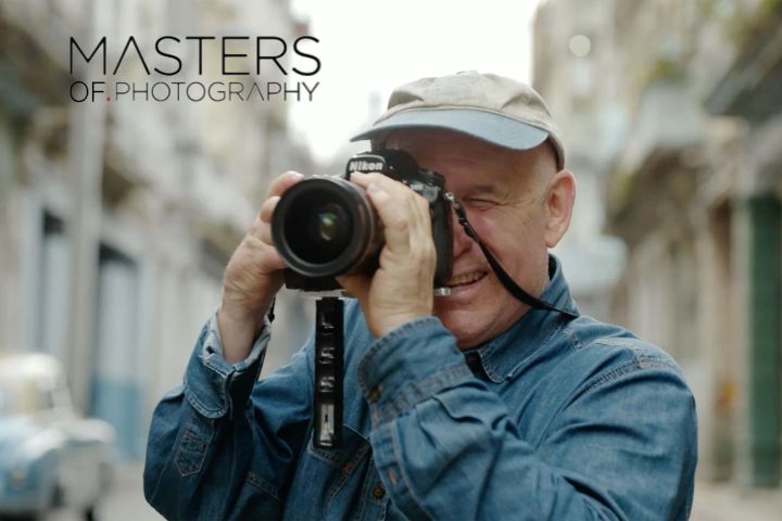 Steve McCurry photographing with a camera during his photography course