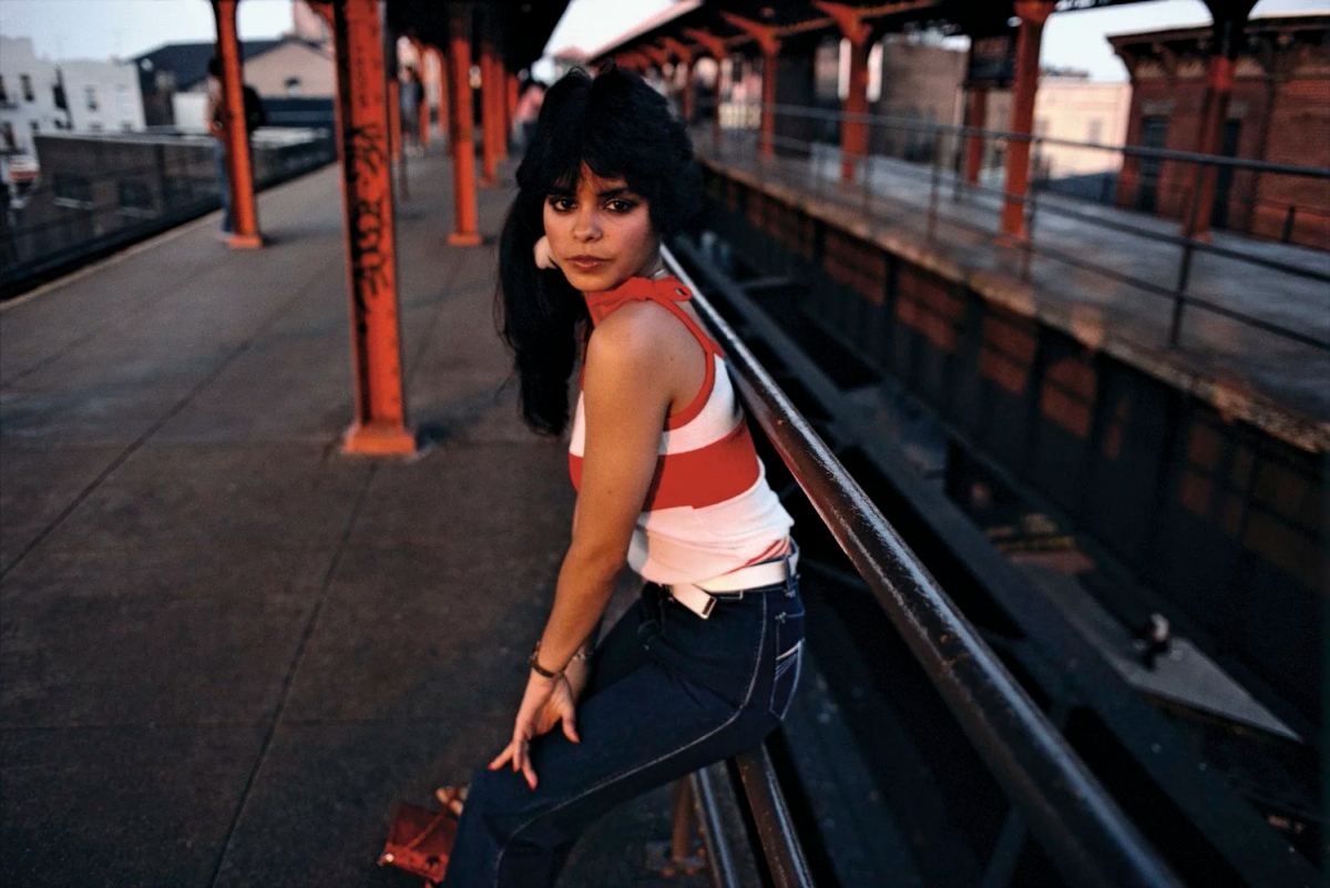 Bruce Davidson photograph of a woman in a striped top on an elevated subway platform