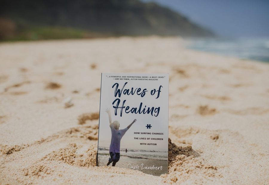 Copy of Waves of Healing standing upright in beach sand with the ocean and bluff in the background