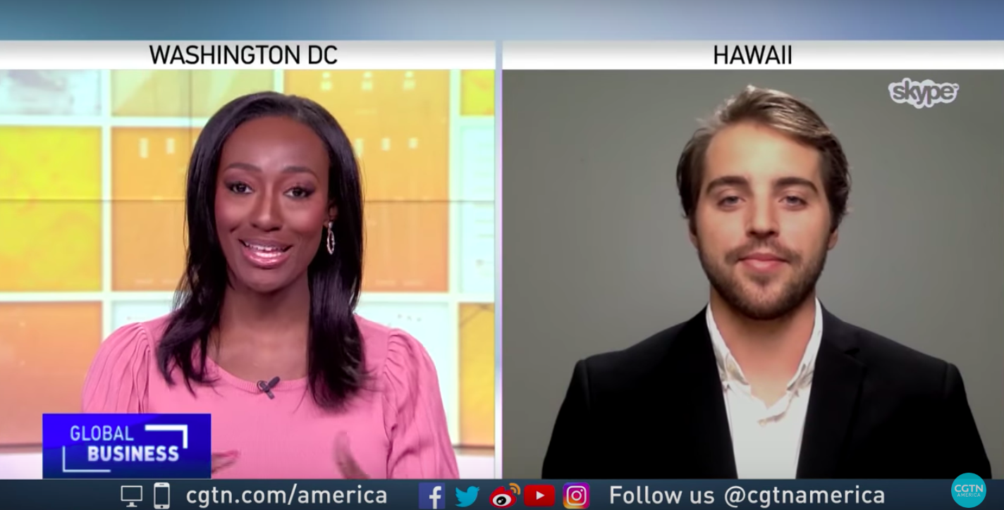 Split-screen CGTN Global Business segment: an anchor in Washington DC and Cash Lambert via Skype from Hawaii