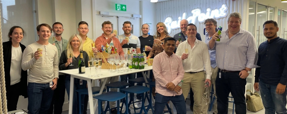 SailPoint employees lining up for a picture during a happy hour