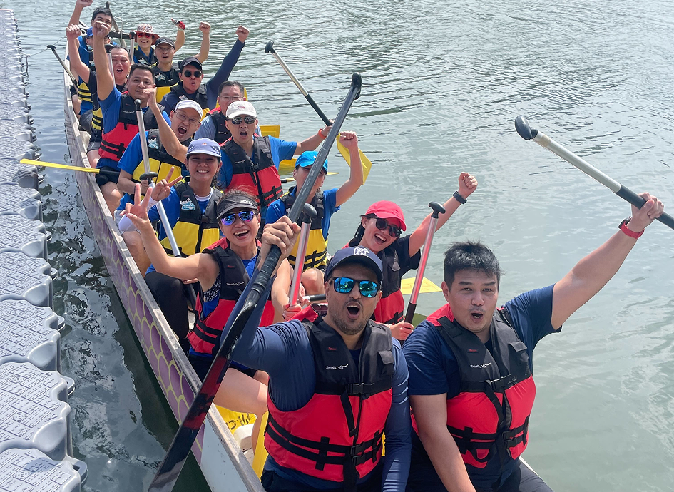 SailPoint crew members celebrating in a dragon boat on the water