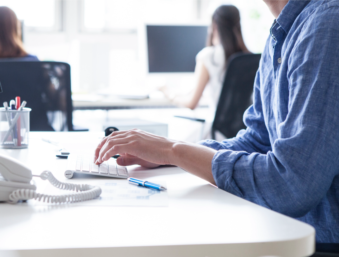 An office worker typing on a keyboard