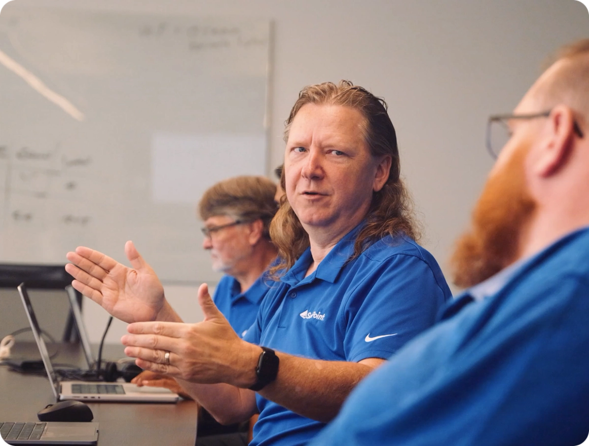SailPoint employees collaborating in a meeting room