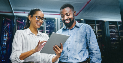 Two IT professionals in a server room