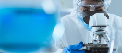 Lab researcher looking into a microscope