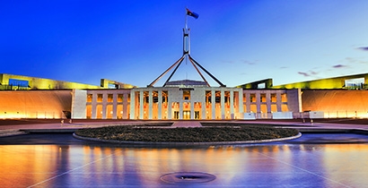 Australian Parliament House illuminated at dusk in Canberra, Australia.