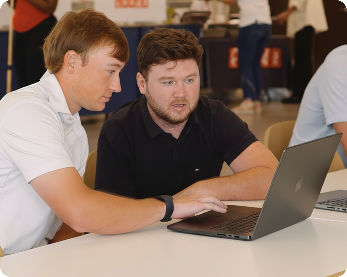 Product management interns collaborating on a laptop