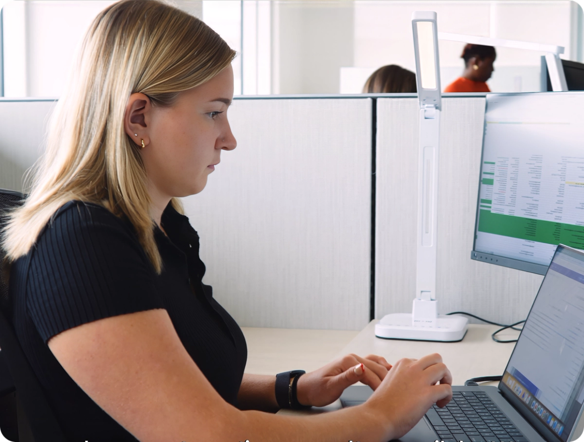Entry-level SailPoint employee working at a computer