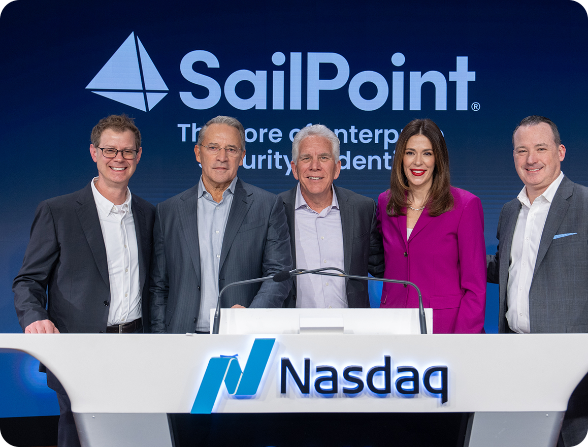 From left to right, Chris Schmitt, Matt Mills, Mark McClain, Abby Payne, and Brian Carolan behind the Nasdaq desk with the SailPoint logo in the background