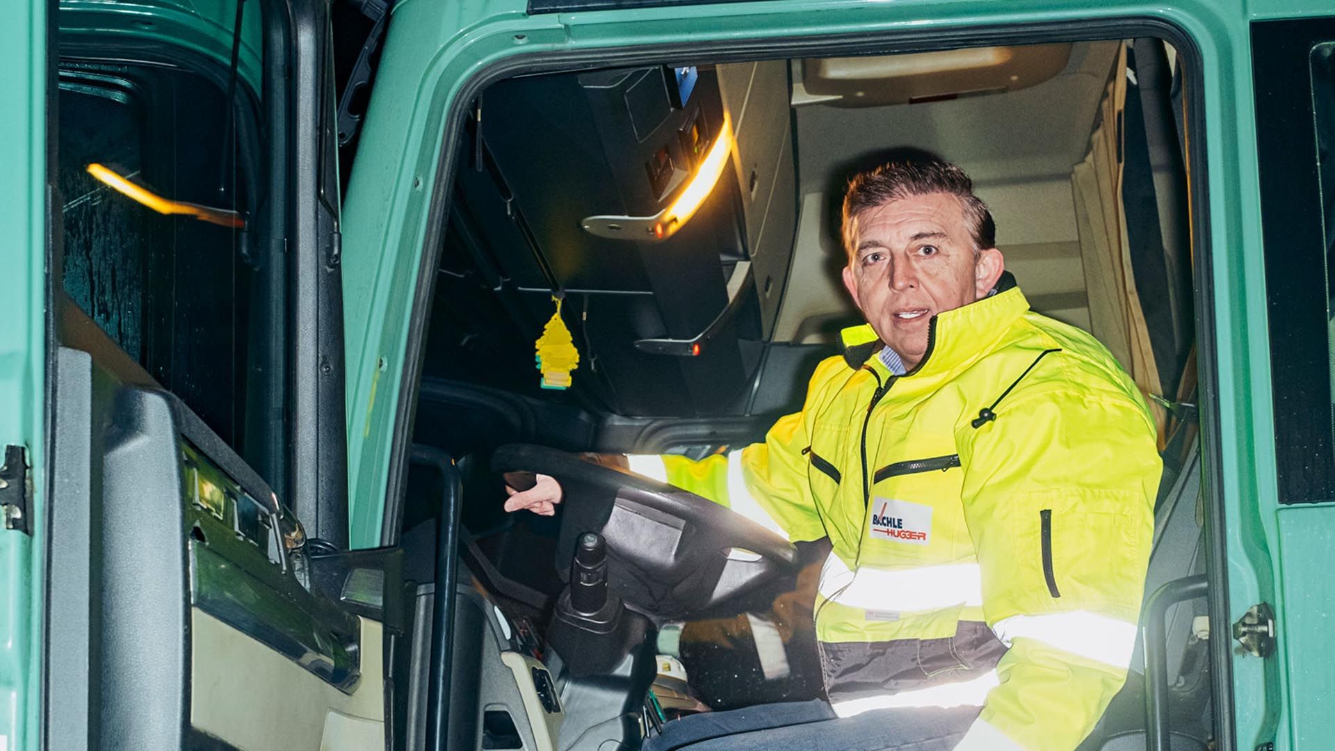 Francisc Szobo is sitting in the lorry with the door open.