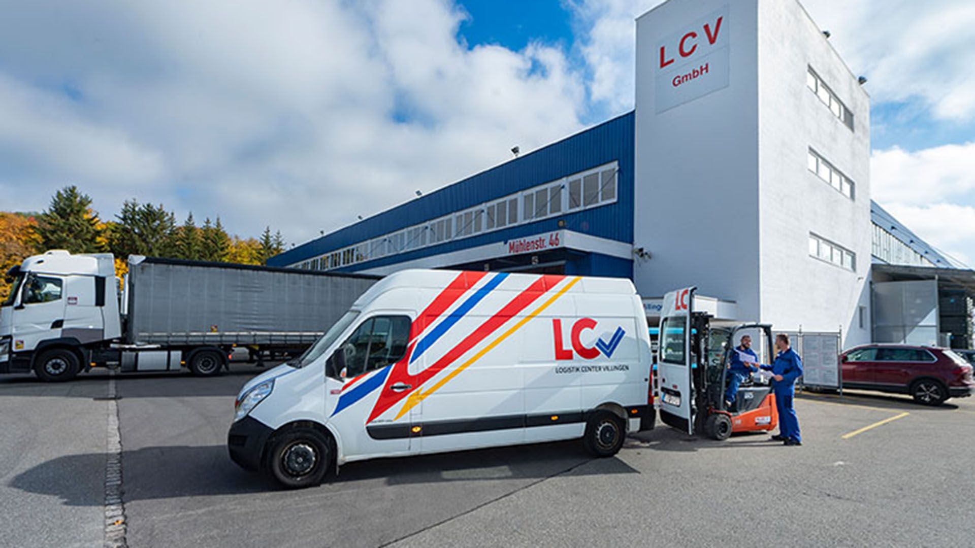 A Swiss Post Cargo truck is parked in front of the LCV headquarters.