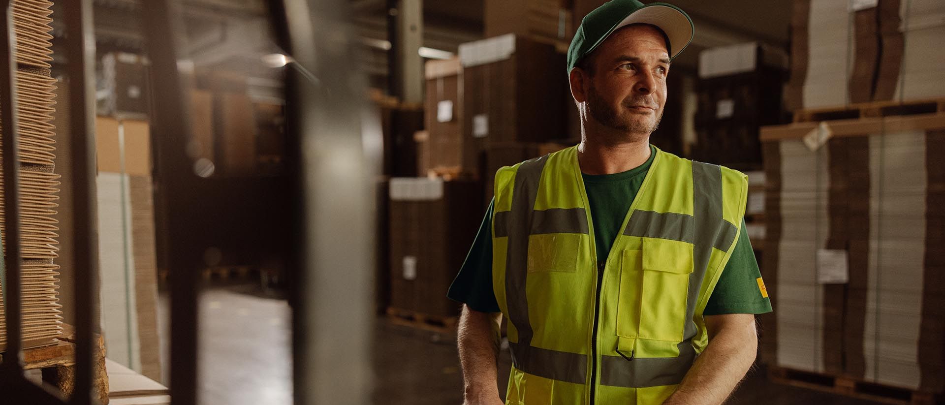 Warehouse employee moves parcels with trolley