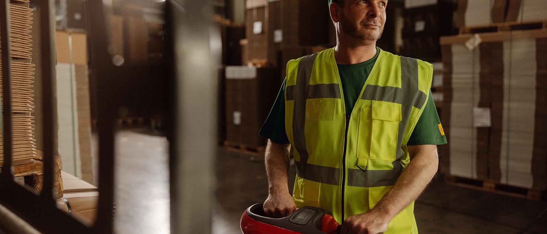 A man moves parcels with a parcel trolly