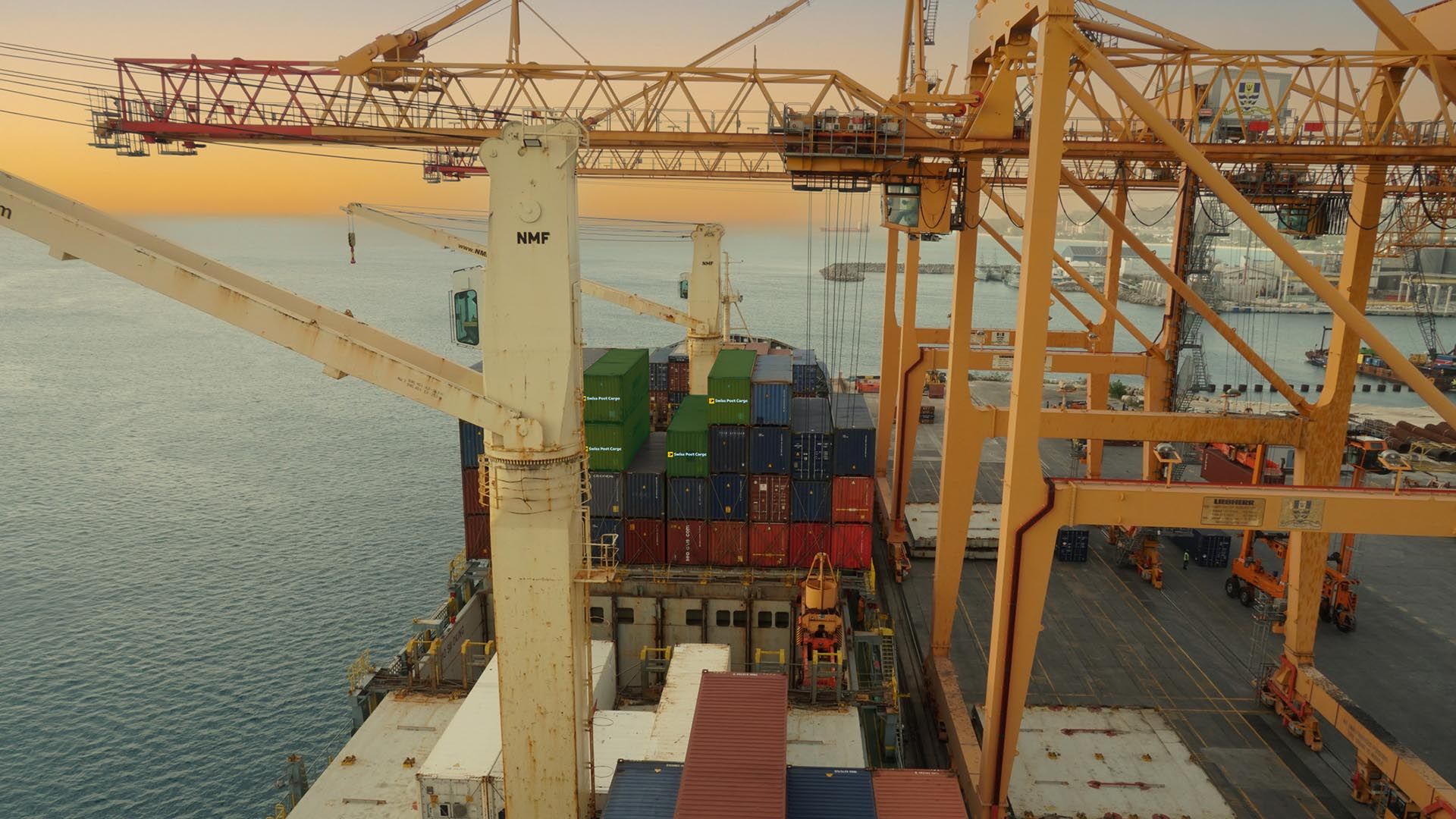 Swiss Post Cargo containers under a cargo crane in the port
