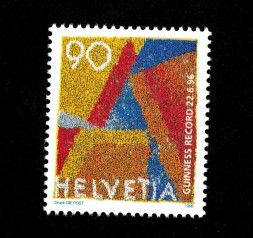 Schweizer Briefmarke mit farbigem abstraktem Muster in Gelb, Rot und Blau. Aufschrift: ‚90‘, ‚Helvetia‘ und ‚Guinness Record 22.6.96‘.