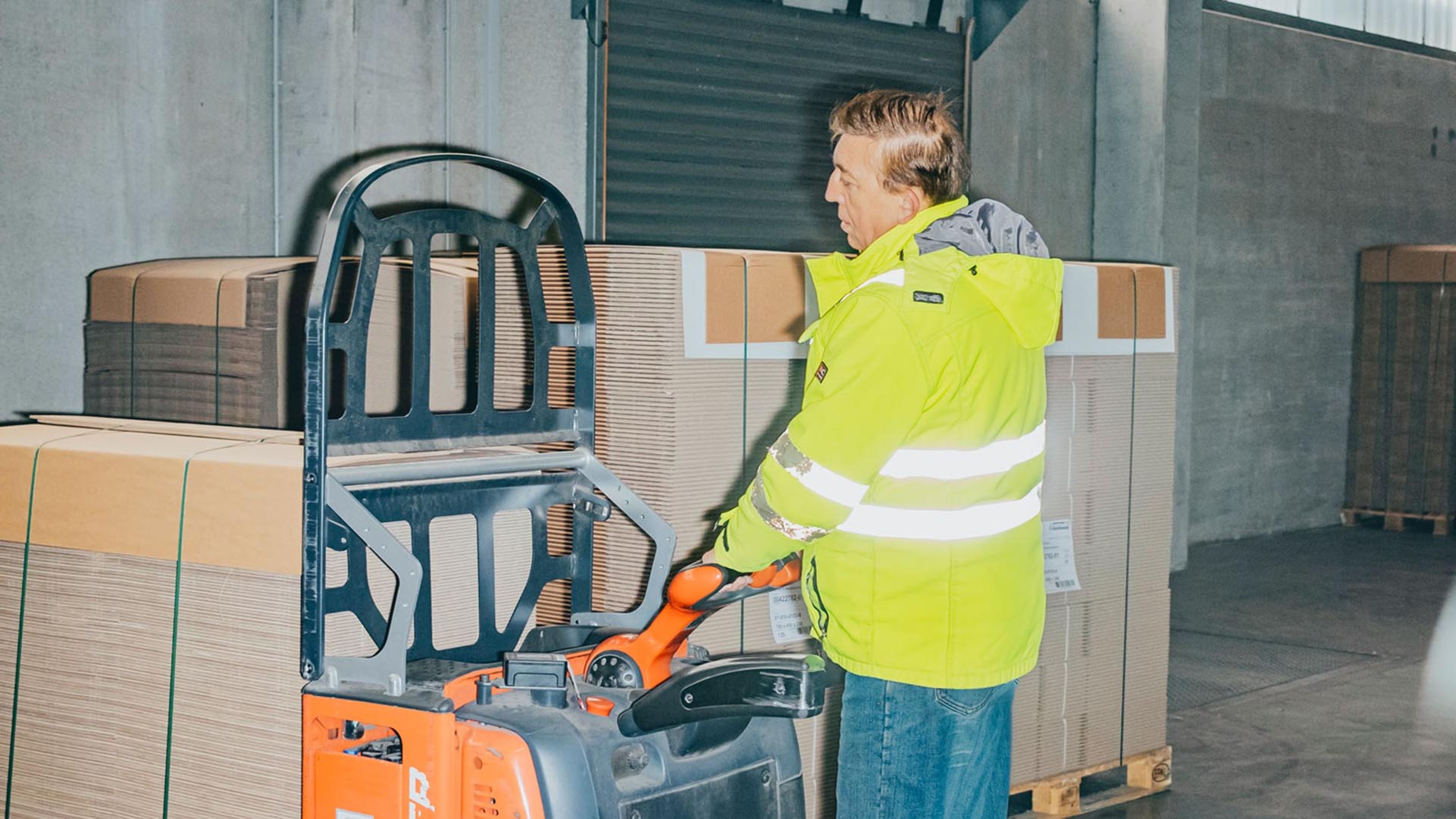 Francisc Szobo loading the goods with a forklift lorry.