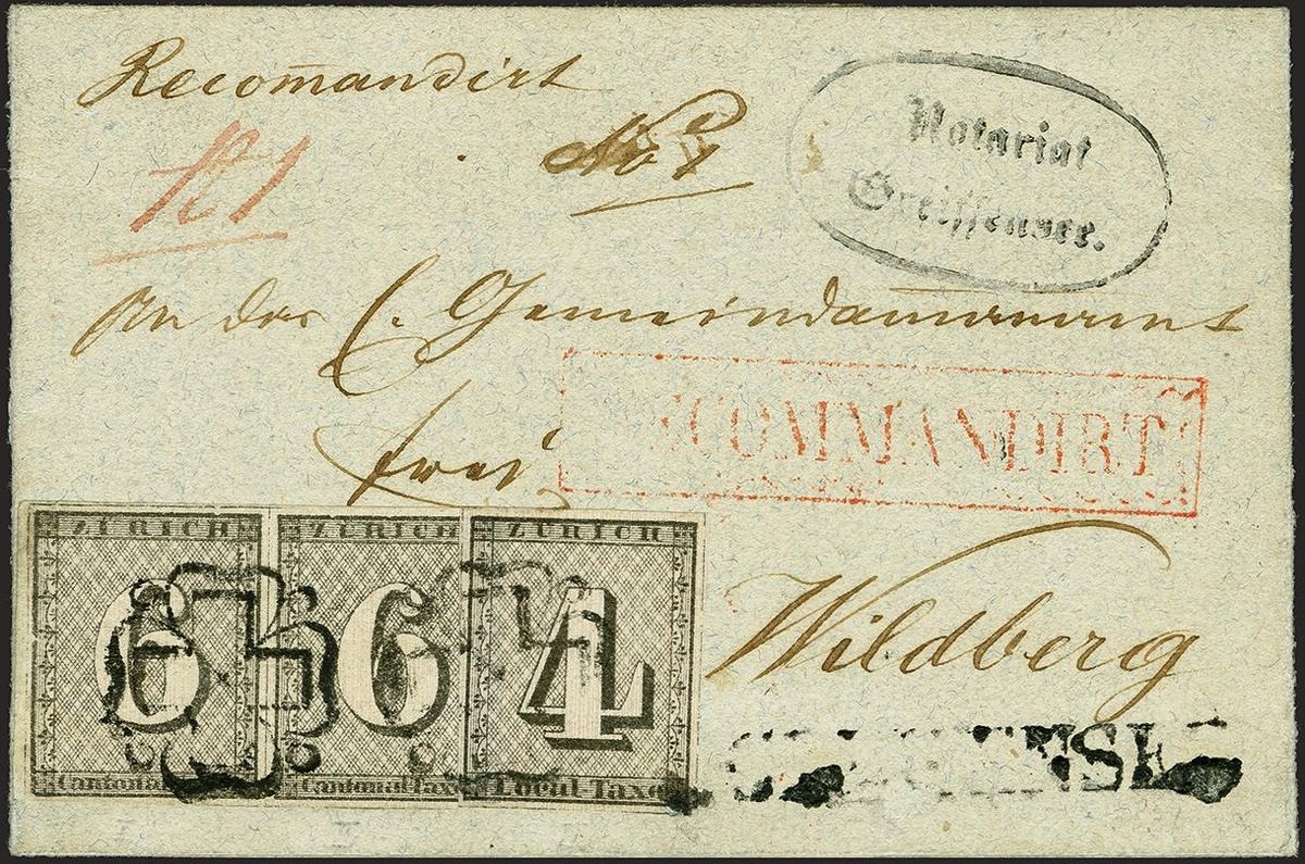Lettre historique avec adresse manuscrite « Wildberg » et plusieurs mentions postales en rouge et noir, dont « Recommandirt » et un cachet ovale « Winterthur ». En bas, trois timbres noirs de taxe cantonale de Zurich alignés avec grands chiffres et motif fin.