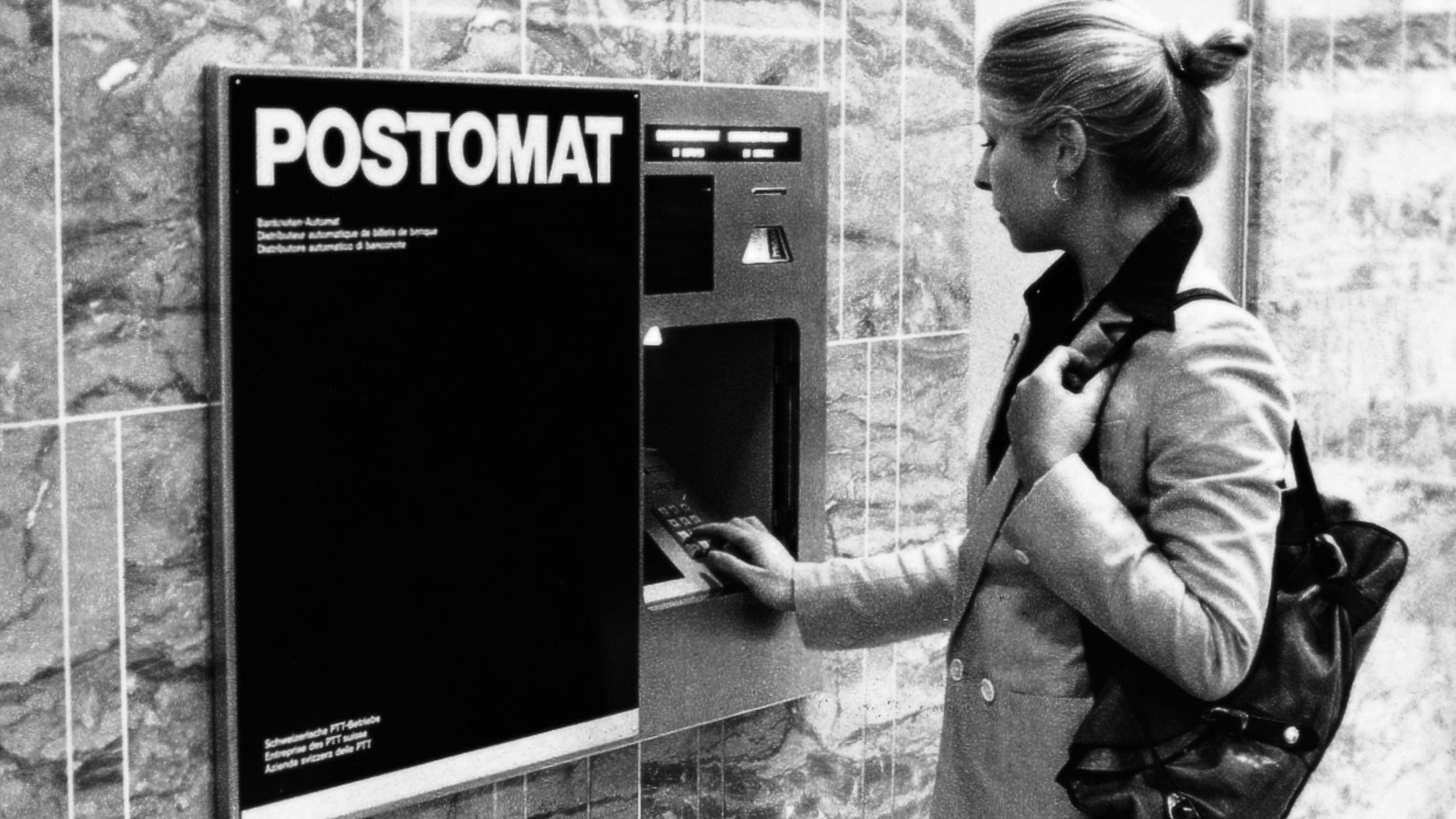 Customer withdraws money from Postomat. Photo: Peter Baur, Herrenschwanden. Source: Museum of Communication