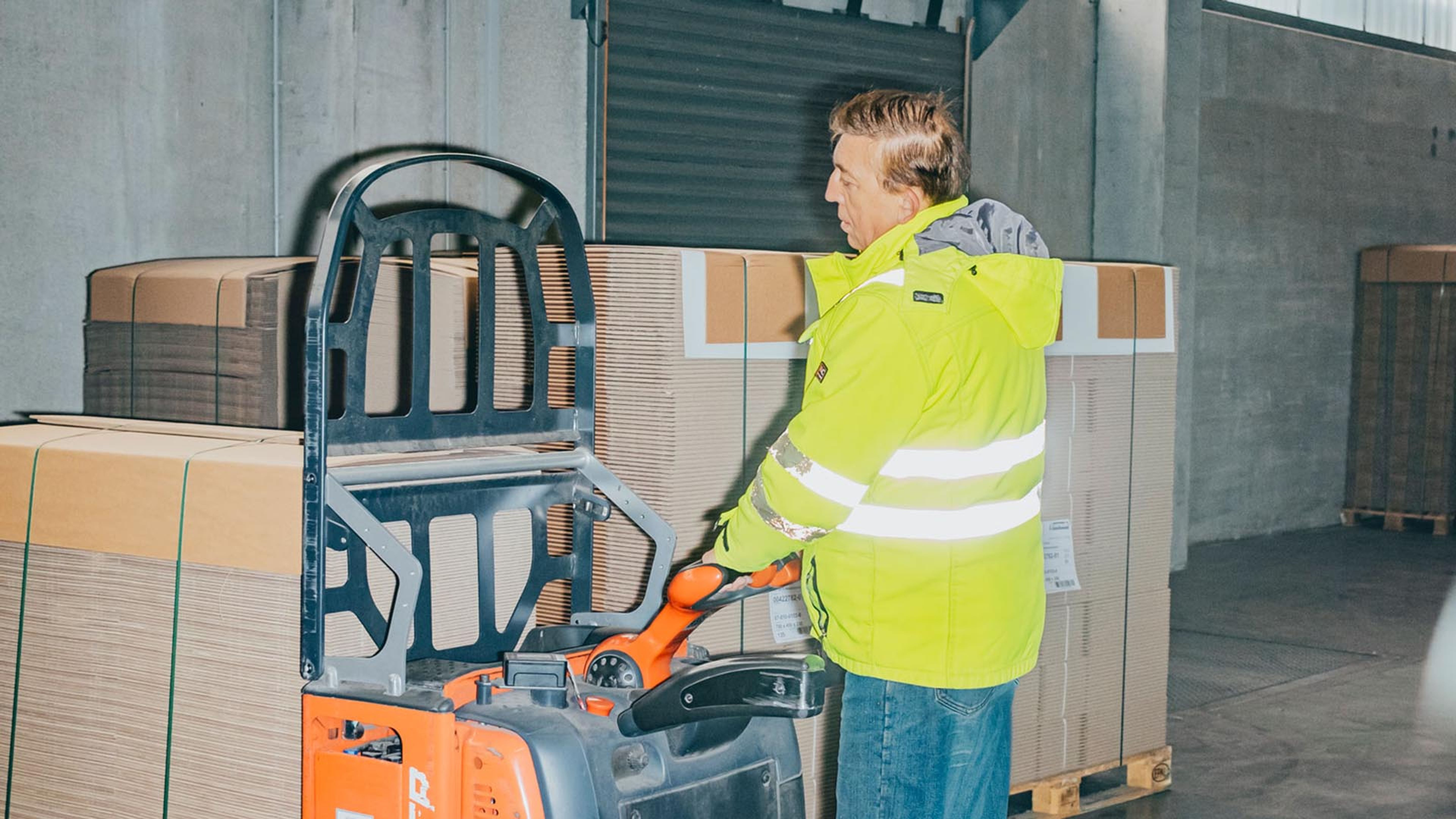 Francisc Szobo loading the goods with a forklift lorry.