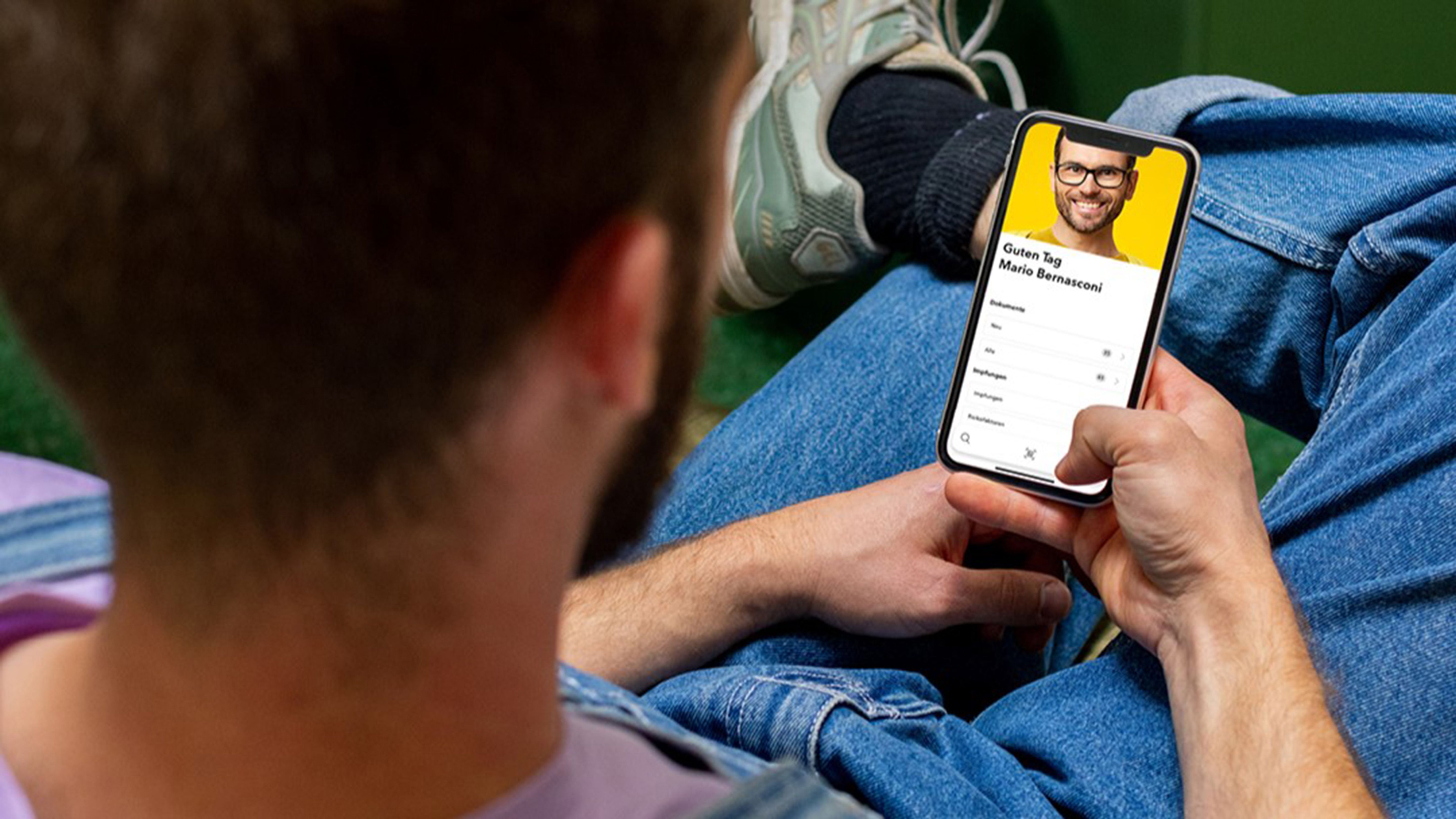 Uomo con smartphone che mostra un’immagine del profilo.