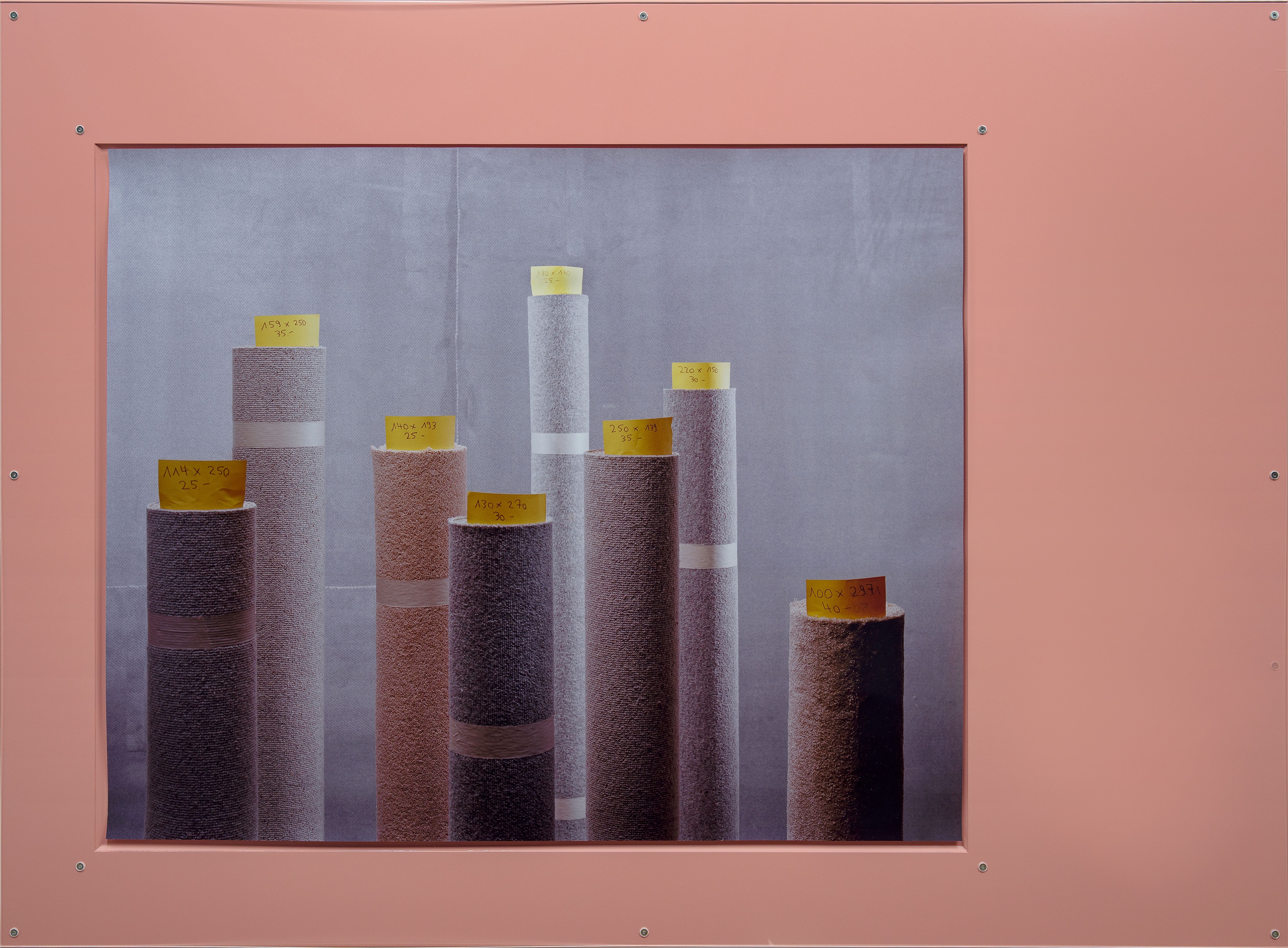 Various rolls of fabric with labels in a pink frame.