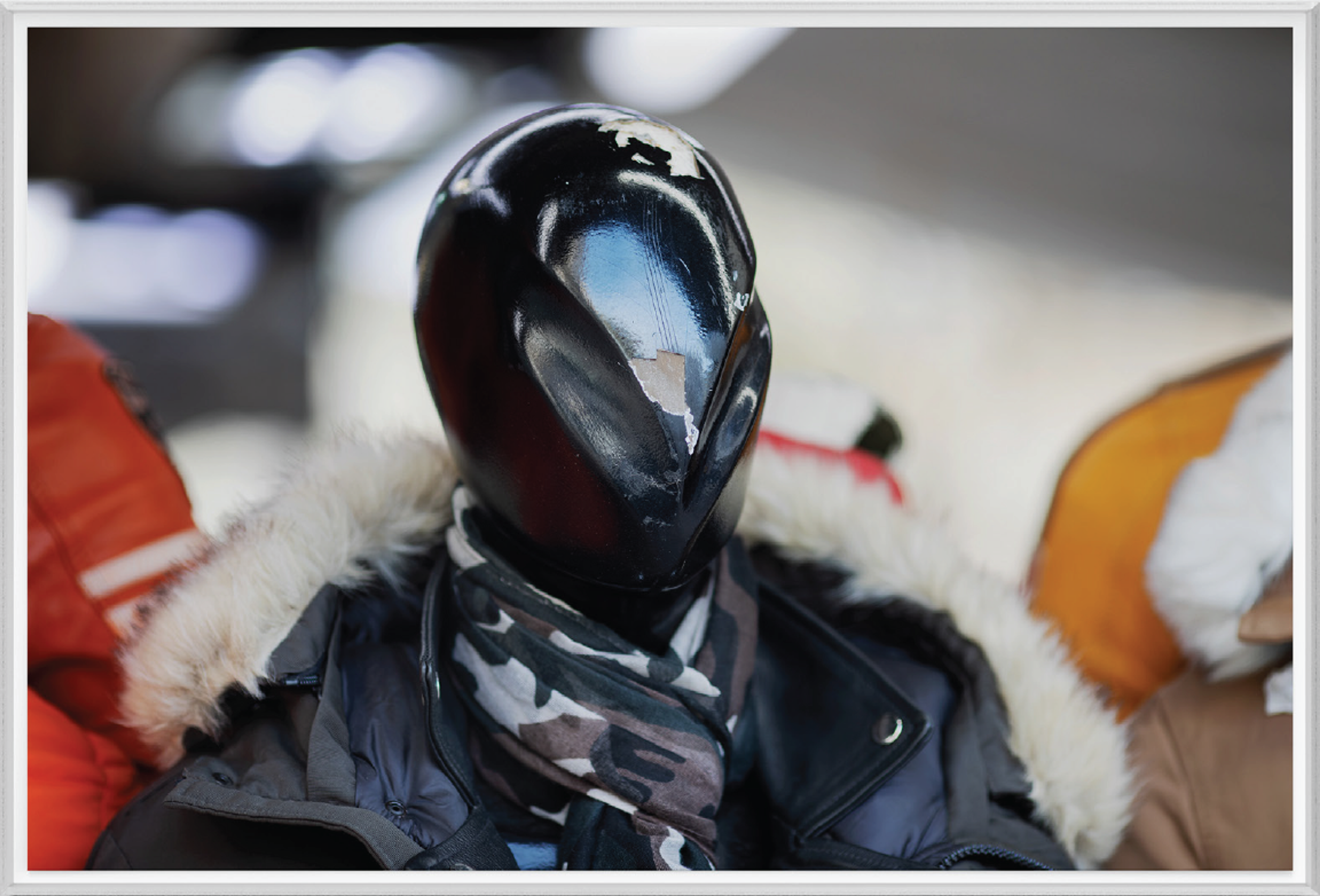 Mannequin in winter clothing against a fuzzy background.