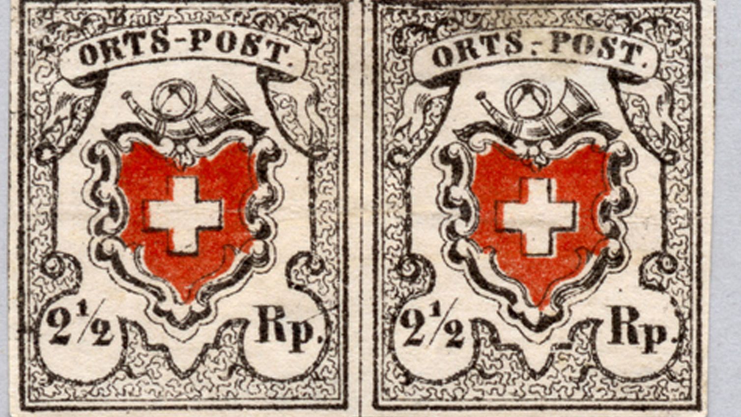 The first stamps valid throughout Switzerland: Swiss cross, postal cor and indication of the value 2 ½ cents.