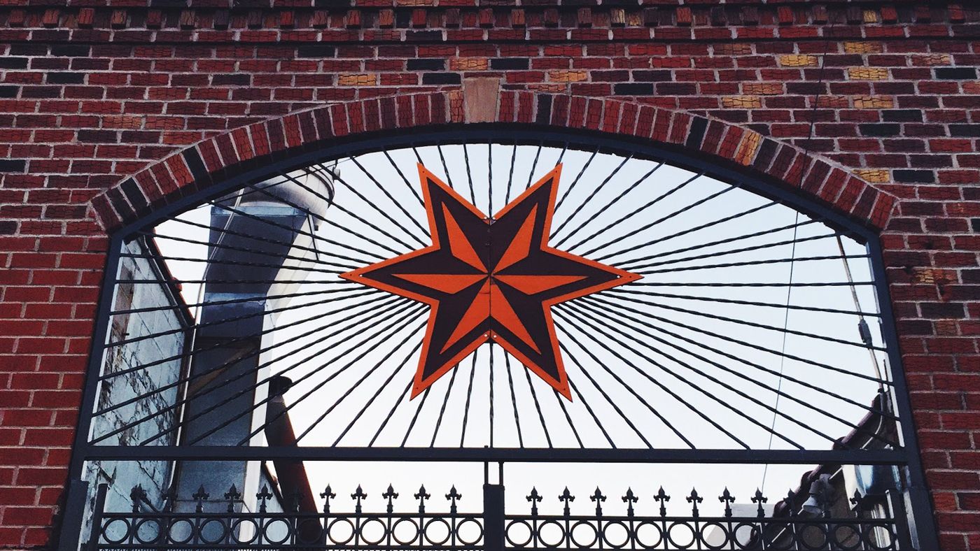 Brick wall with star logo in window