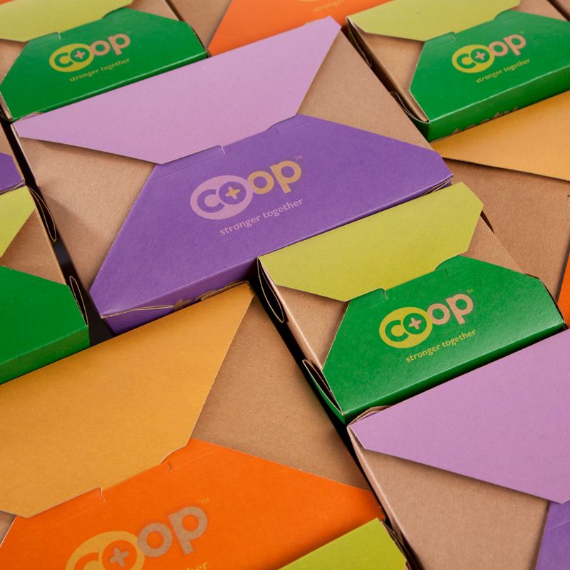 Kraft boxes with colored flap lids and the Co+op logo