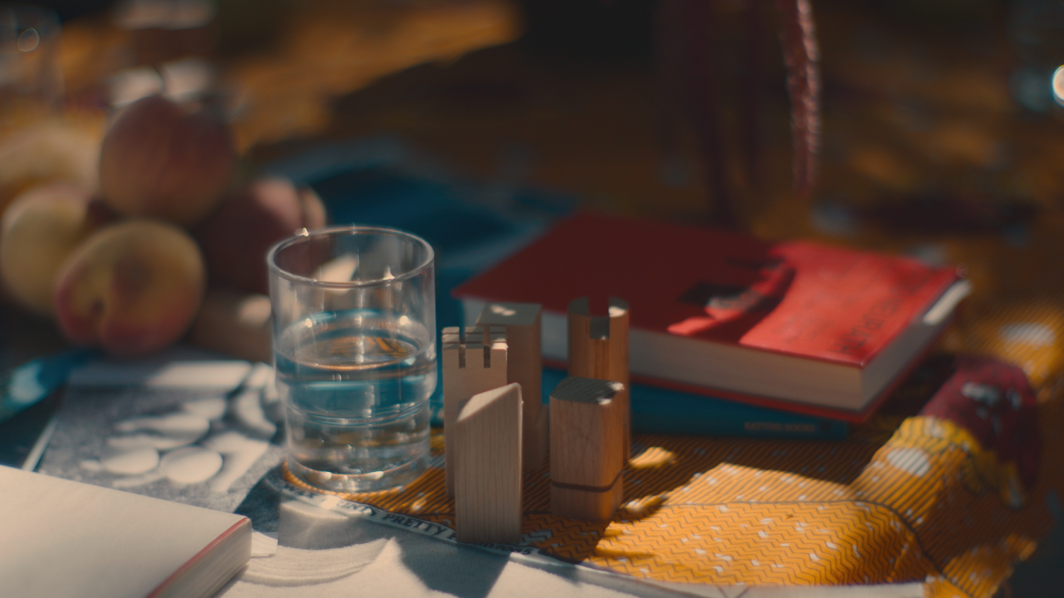 a table with a book and glass on top