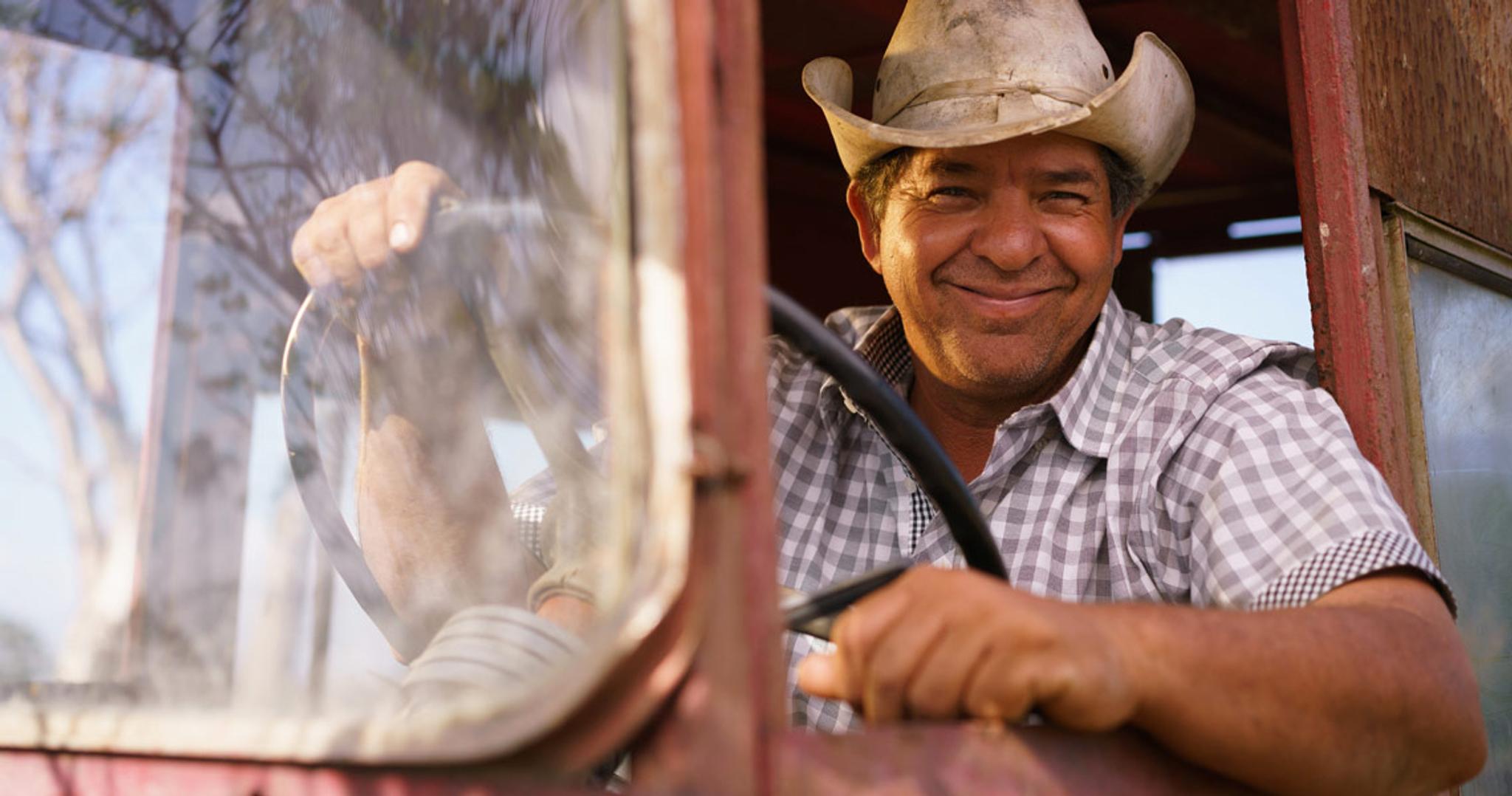 Happy farmer behind wheel