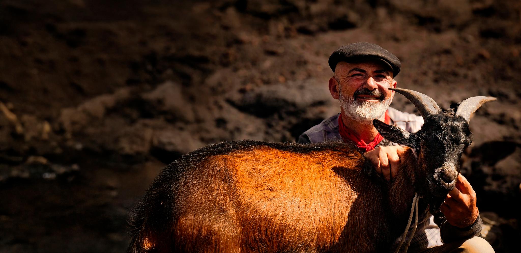 Happy man with goat