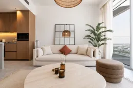 Minimalist living room in Dubai hills Estate, with travertine coffee table and beige cream sofa
