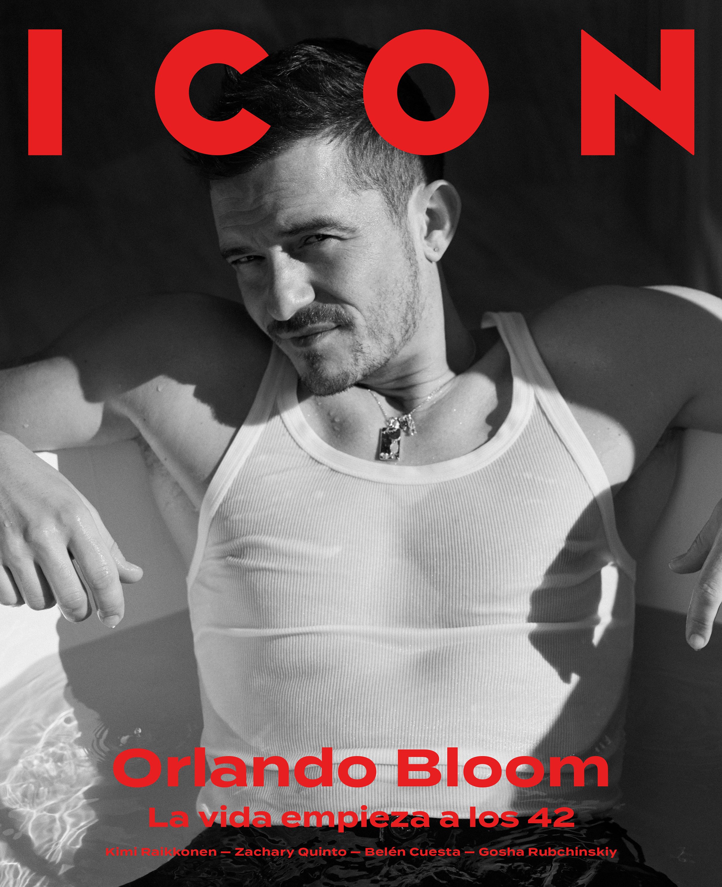 ICON magazine cover: black-and-white portrait of Orlando Bloom in a white ribbed tank top and pendant necklace, leaning back in water with a sideways glance