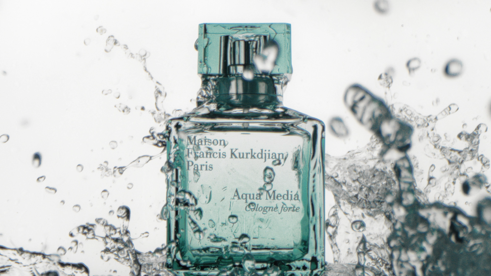 Still from a personal video project: a Maison Francis Kurkdjian Aqua Media Cologne Forte bottle splashed with water, with droplets frozen mid-air around it