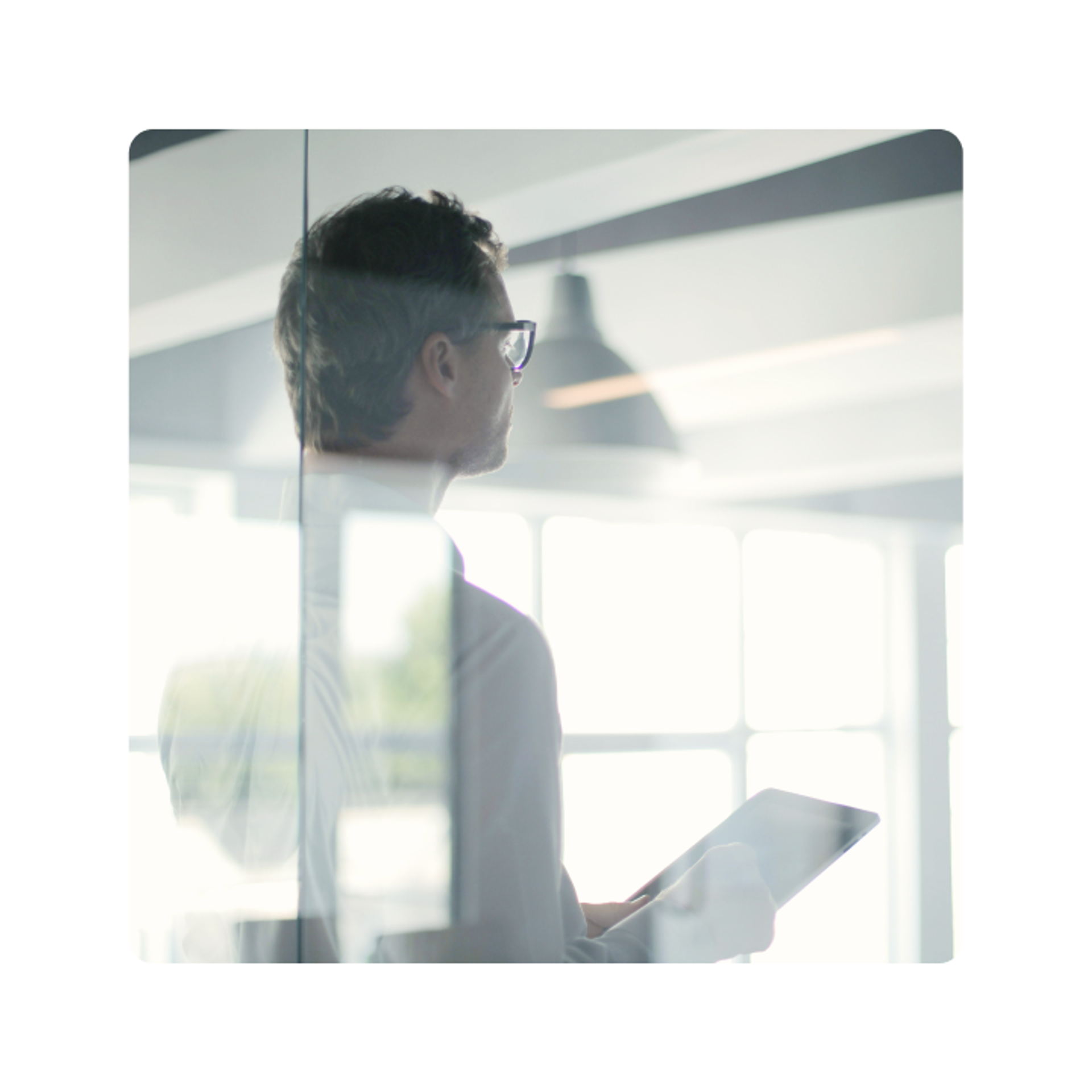 Business professional holding a tablet in a modern office environment
