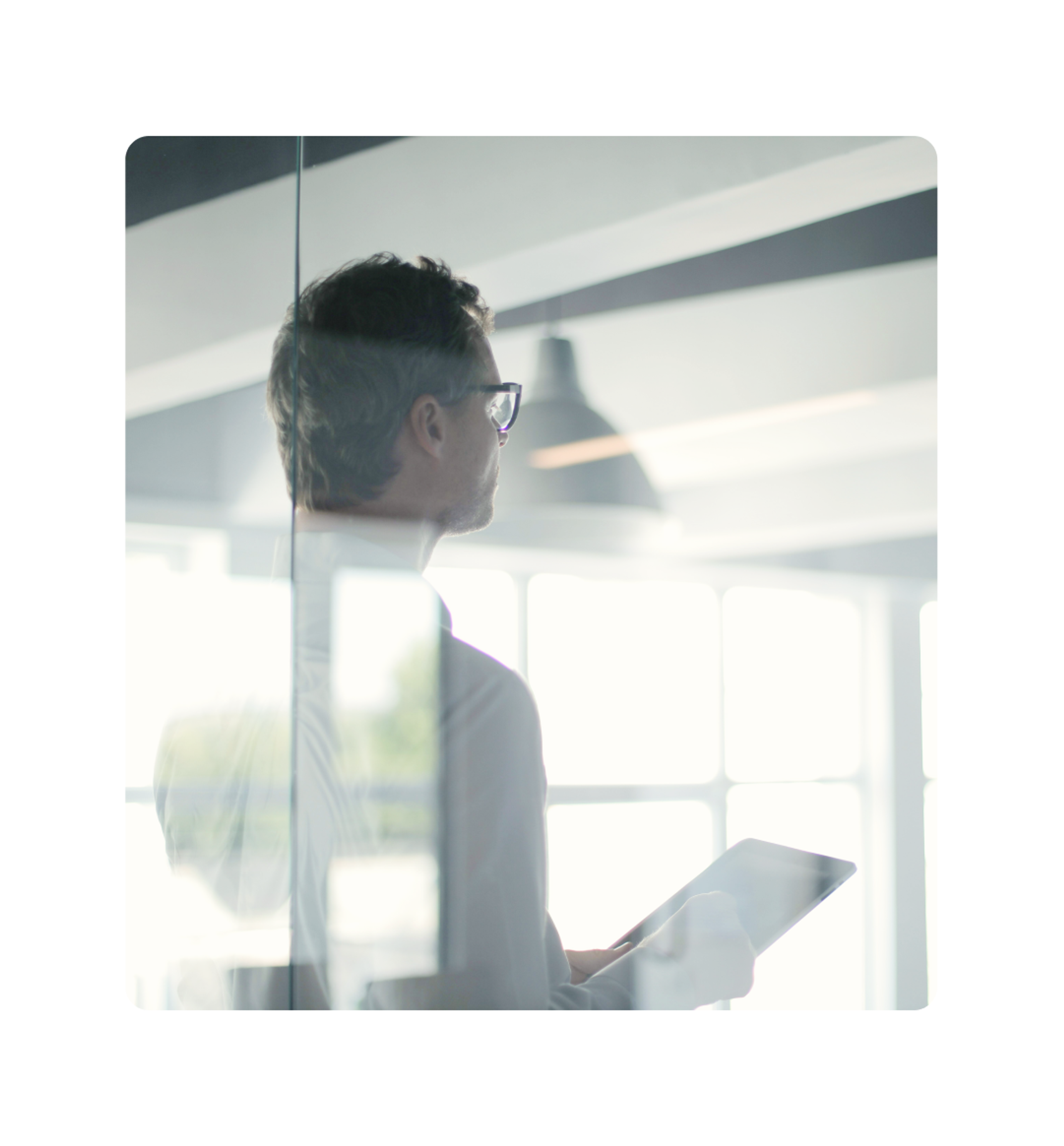 Business professional holding a tablet in a modern office environment