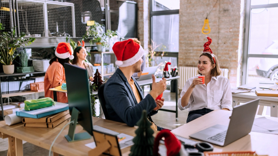 Employees at the office with Christmas decoration and Christmas hats