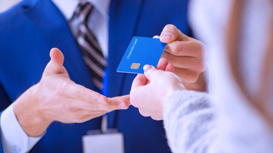 Man with blue suit receiving a corporate card