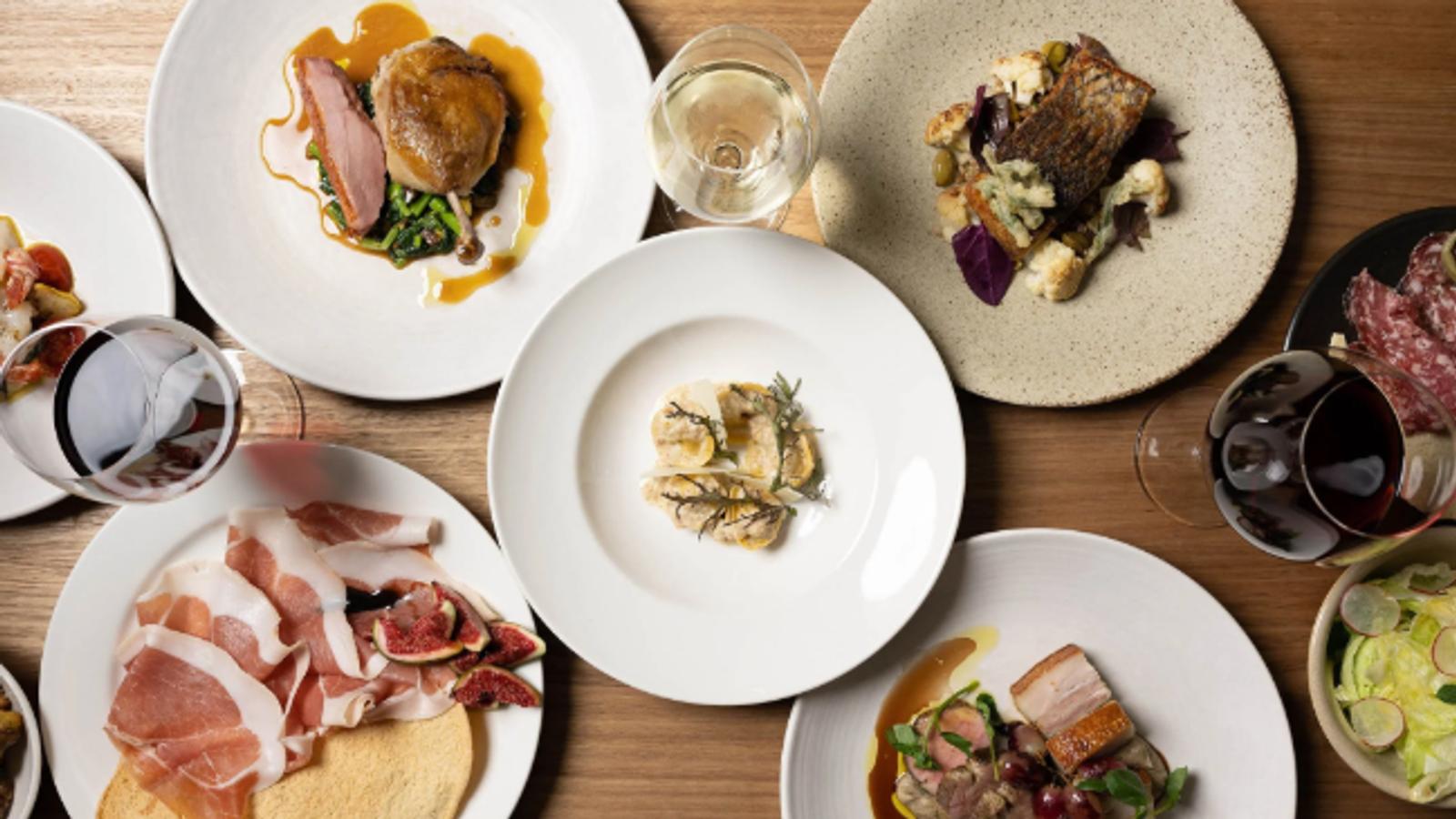 Elegant fine dining plates with wine at a private dinner