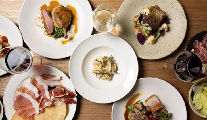 Elegant fine dining plates with wine at a private dinner