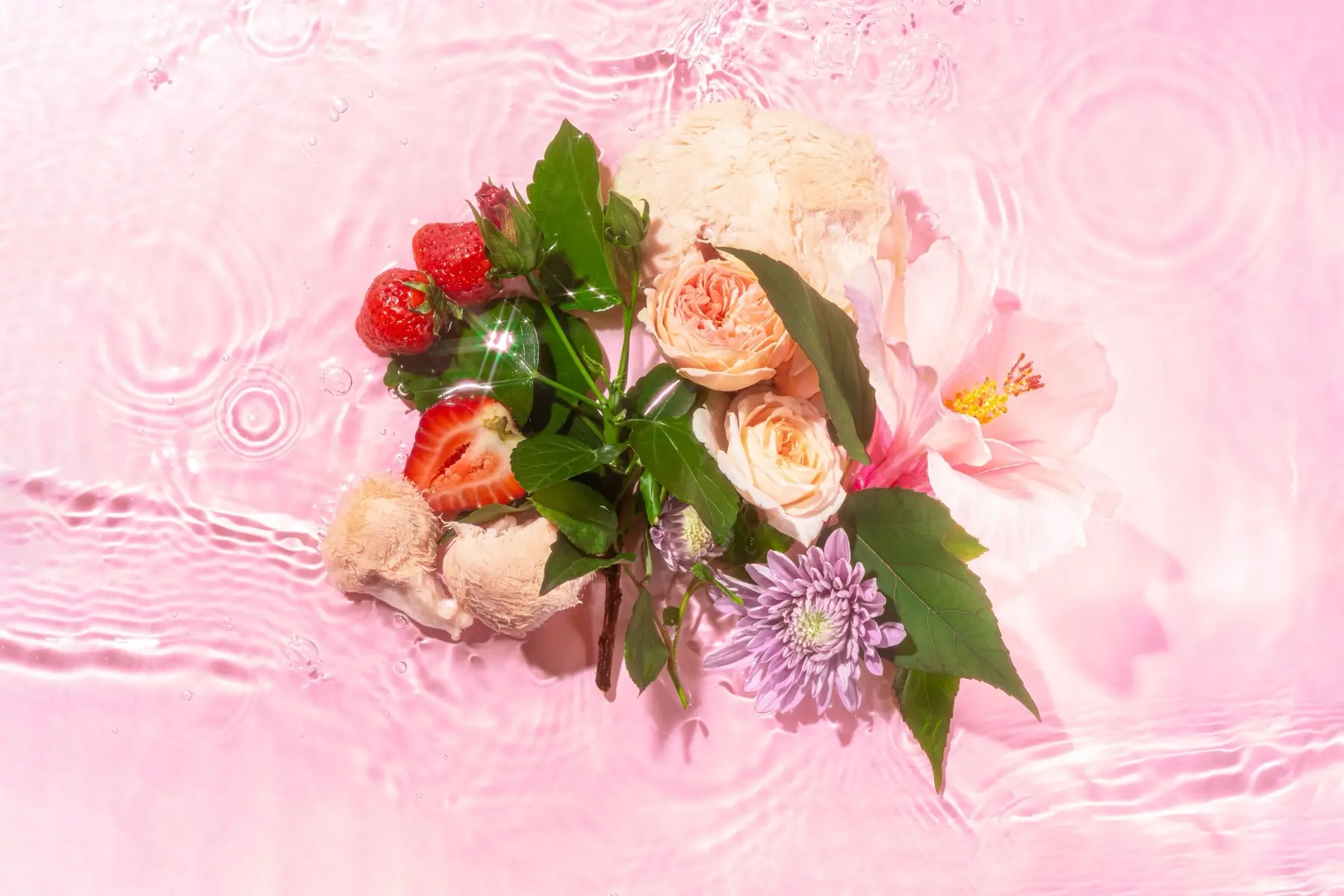 Image of red, pink, white, and purple flowers and strawberries on a pink background.