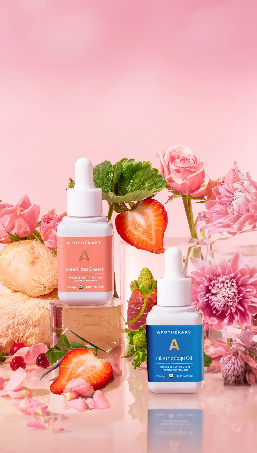 product feature of Rosé-Tinted Glasses and Take the Edge Off against floral backdrop with strawberries and Lion's Mane
