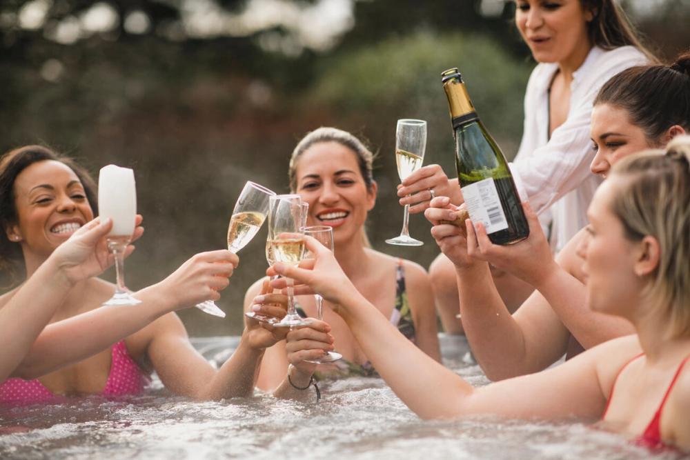 Hens toasting with some bubbly in a hot tub
