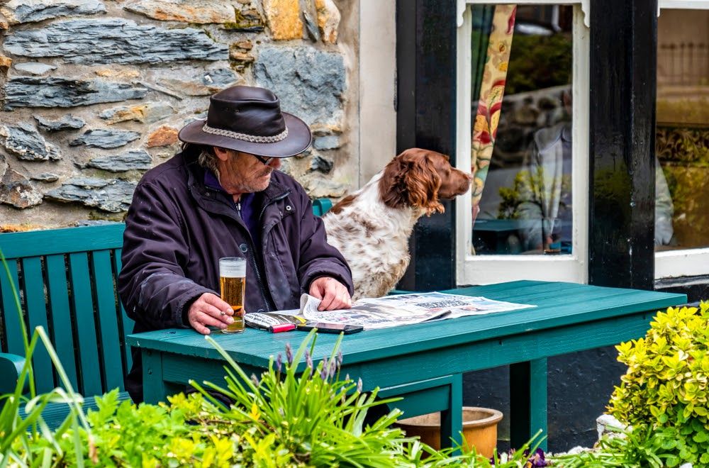 A man and his dog enjoy their local pub