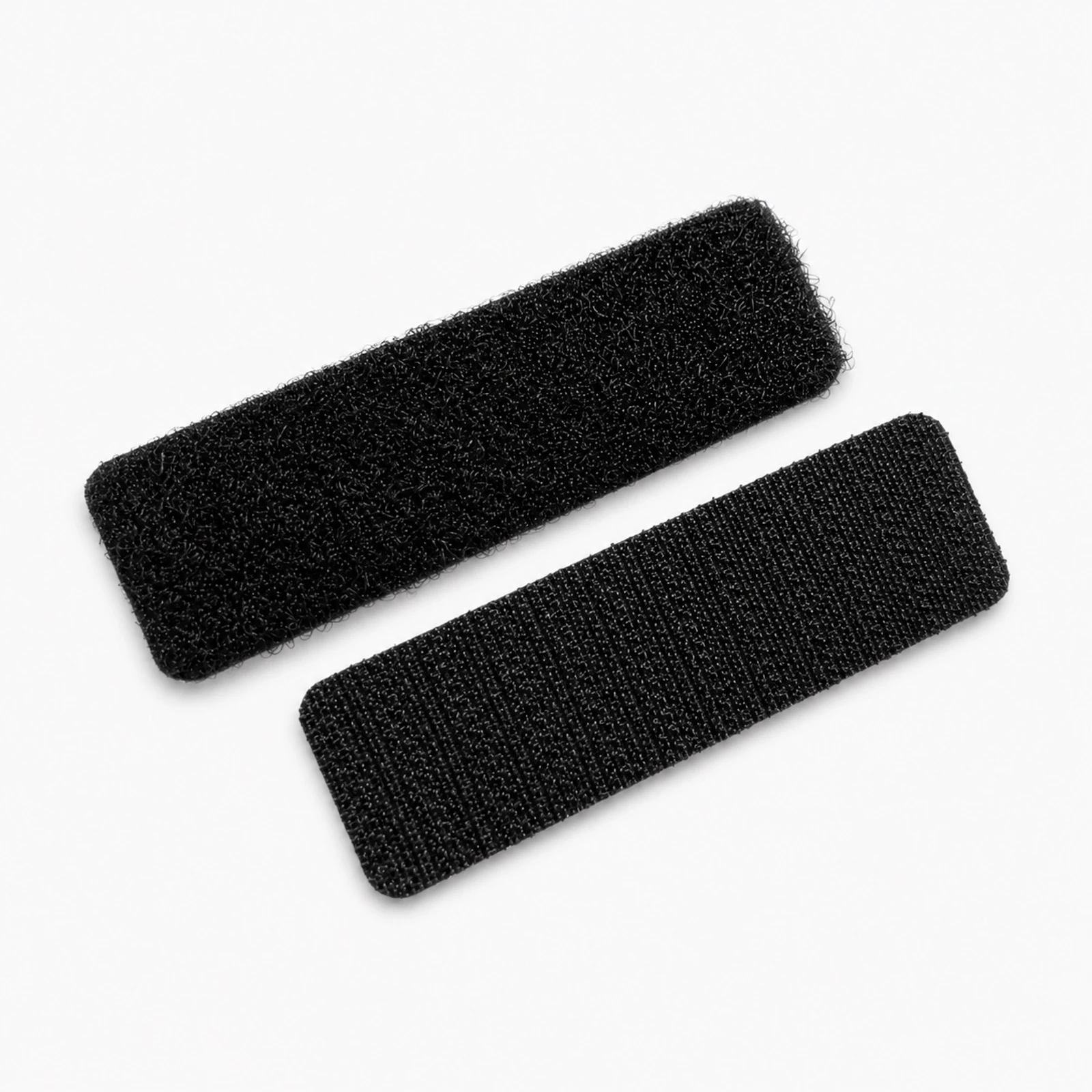 Two black adhesive hook-and-loop strips for fastening and marking on smooth surfaces.