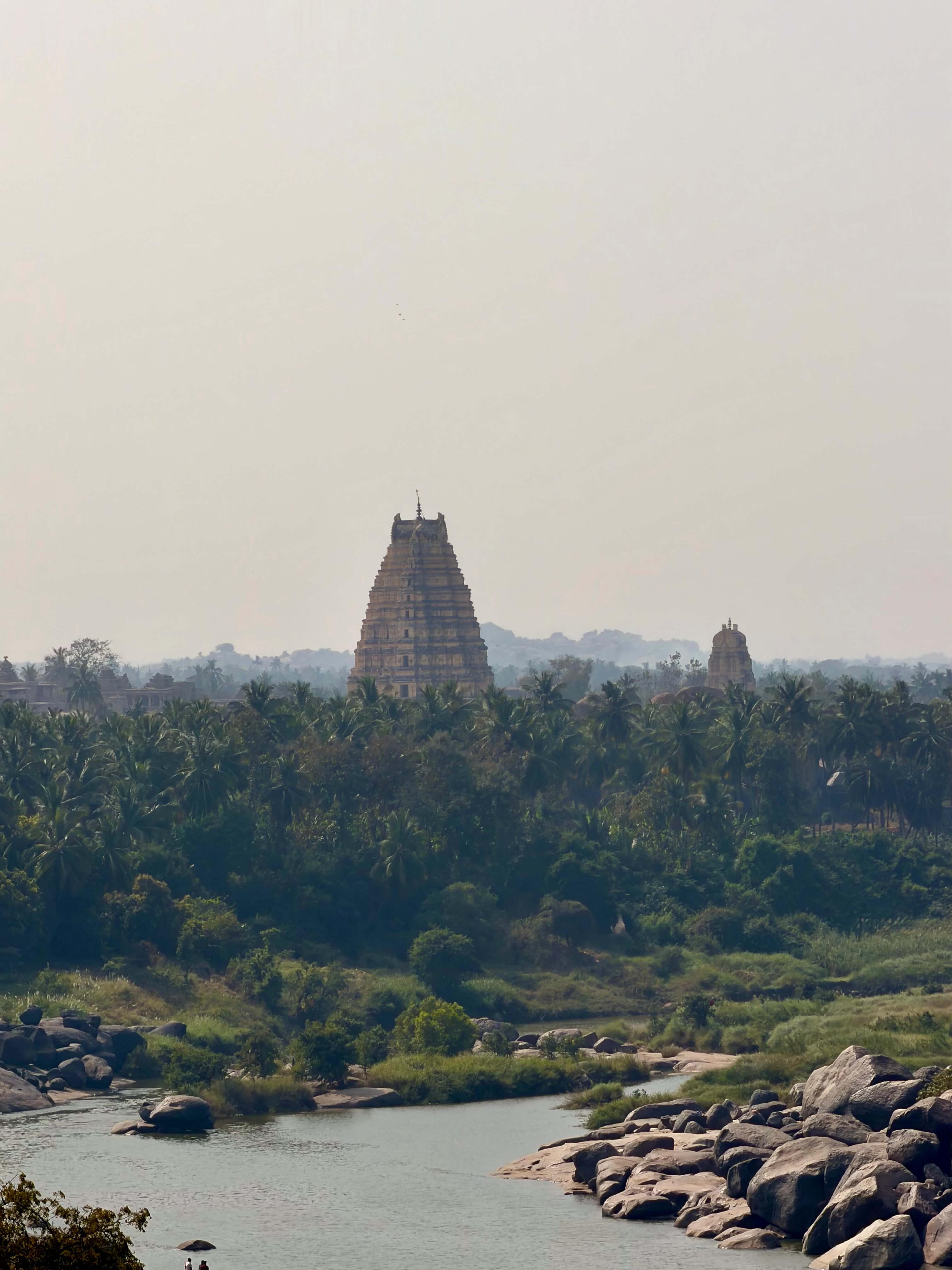 Scenic view over the Tungabhadra river onto the Virupaksha Temple in Hampi. Hampi, Karnataka, India
