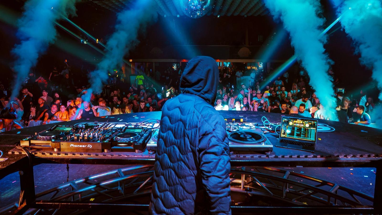 A DJ using Serato DJ Pro in a live venue